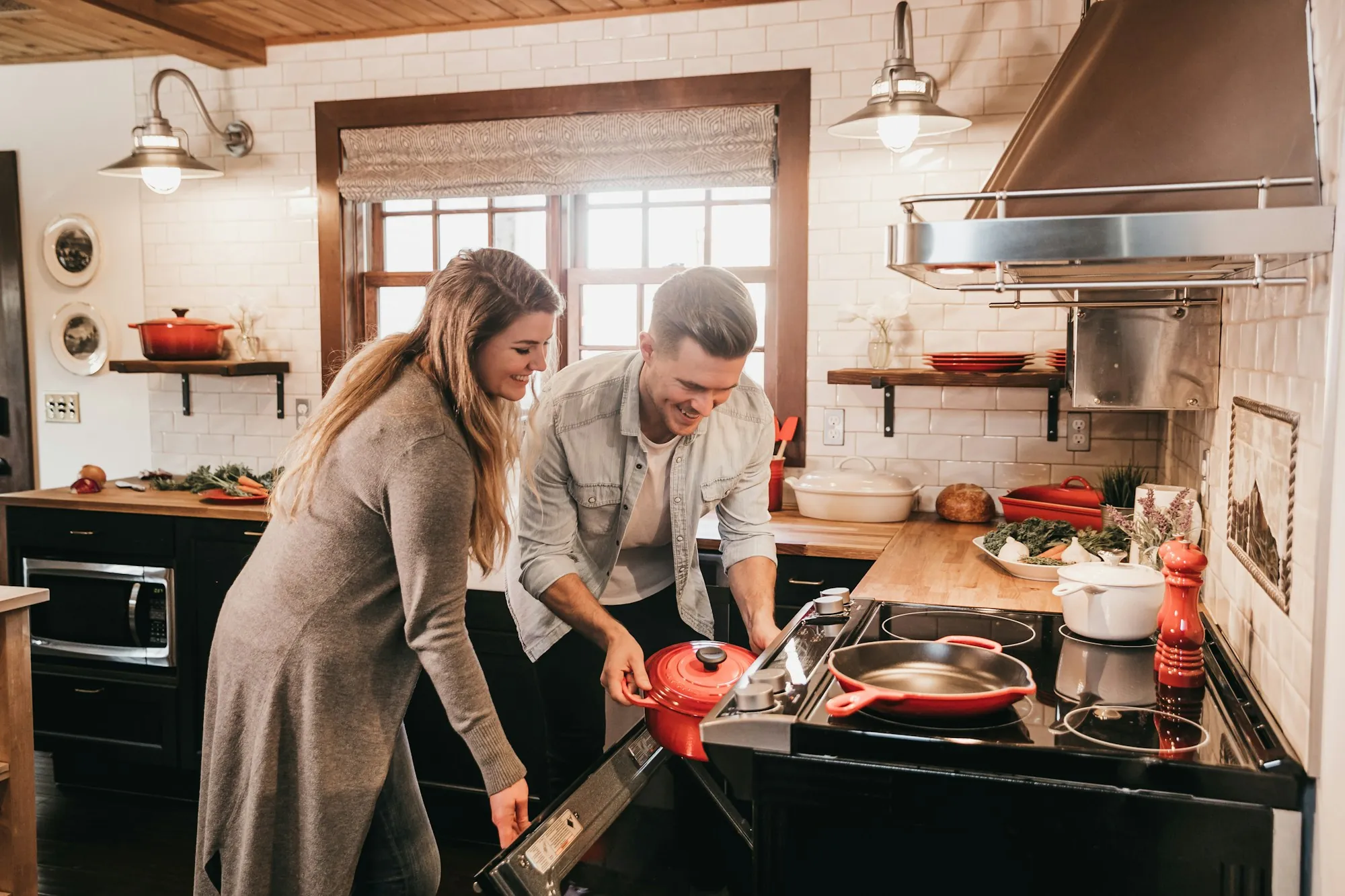 Couple cooking together at a kitchen range